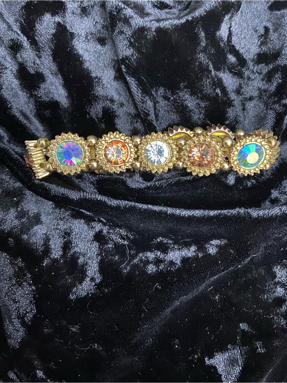 Gold colored bracelet with accent crystal